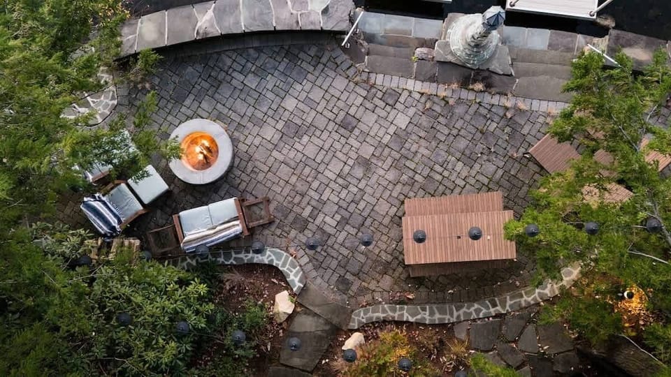 Patio, Island patio with fire-pit, dining table, and loungers