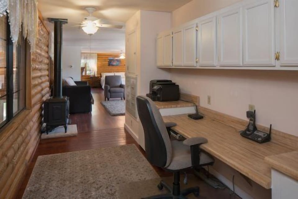 Master Suite: A lavish and exceptionally spacious environment with a King-sized bed, 2 Twin with Trundle beds (Room Sleeps 6), a massage chair, and a dedicated office workspace.
