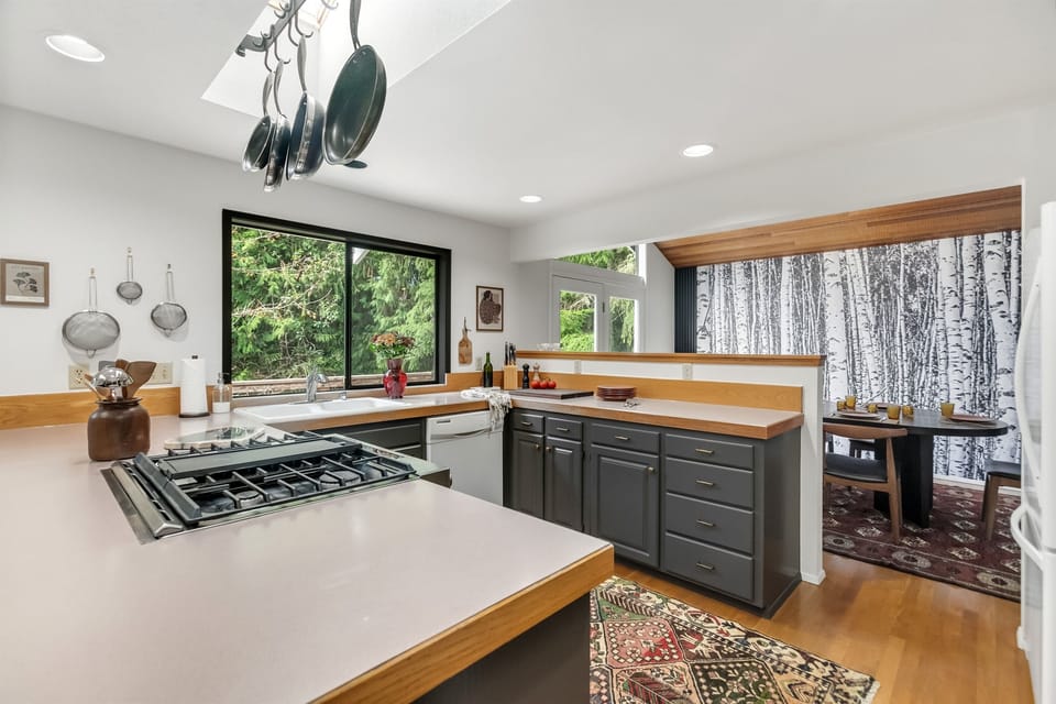 The spacious kitchen comes fully equipped with cooking utensils and tableware.