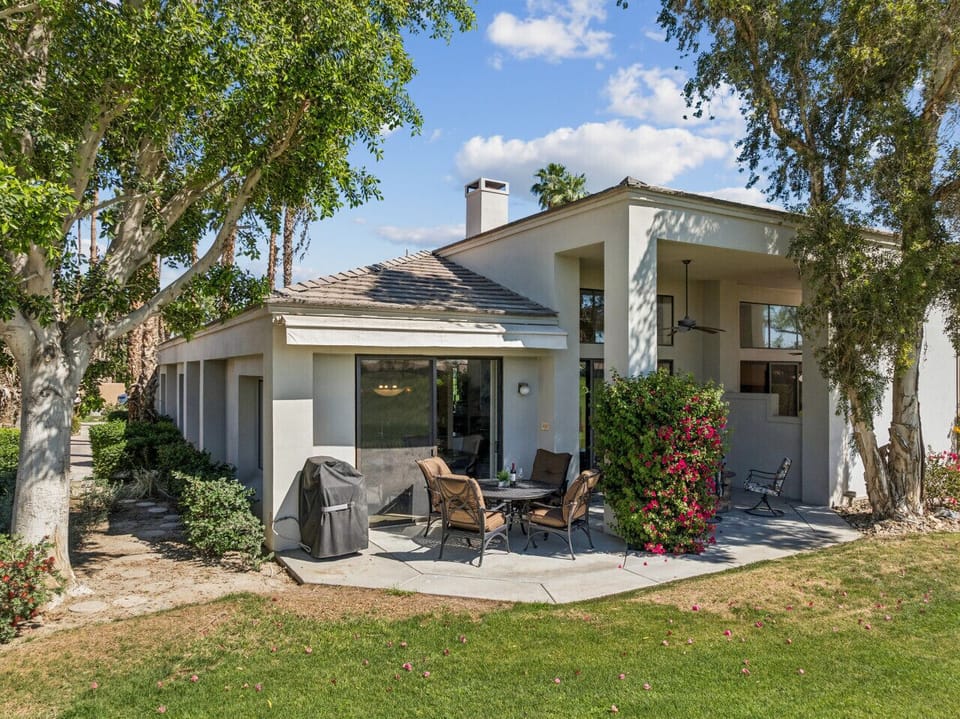 Private patio w/ seating, greenery & shaded space for relaxing outdoors