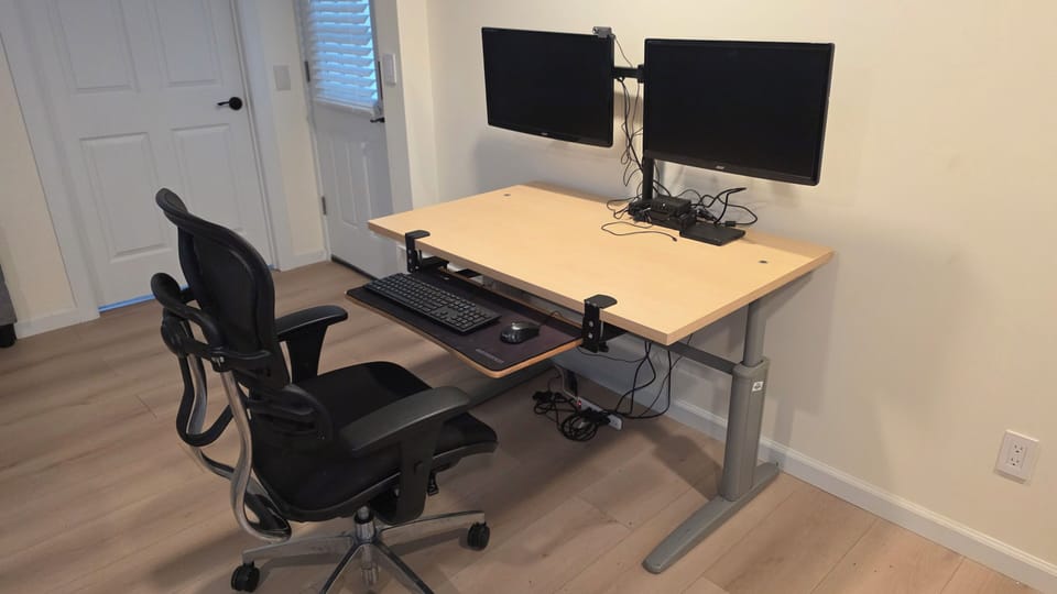 office / computer desk setup with external monitors and docking station. 