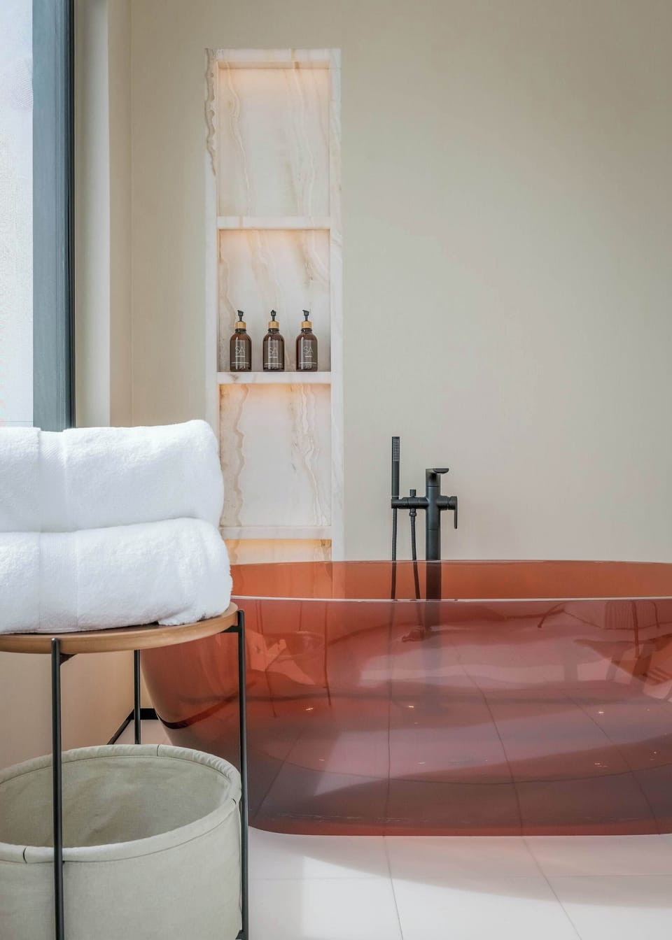 A deep soaking tub set in custom stone, bringing a spa-style bathroom experience into your stay.