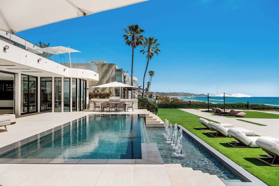 Swim alongside the infinity-edge pool with the oceanfront running the full length beside you.