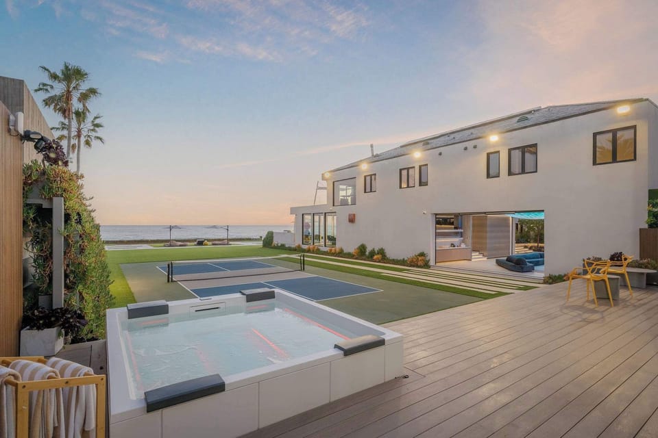 Oceanfront deck with spa features and elevated views over Broad Beach.