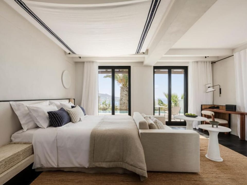 Wake refreshed in a sunlit bedroom with effortless outdoor flow.