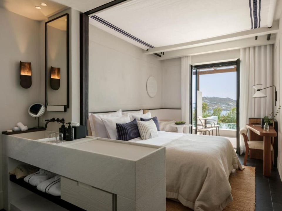 Unwind in crisp linens with serene, airy coastal views.