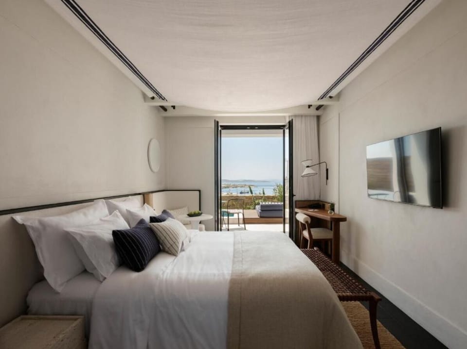 Stretch out in a serene bedroom framed by ocean views.