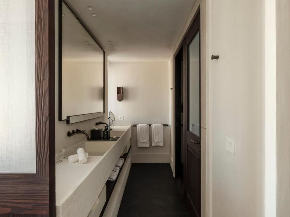 Refresh easily with a sleek vanity and plush towels.