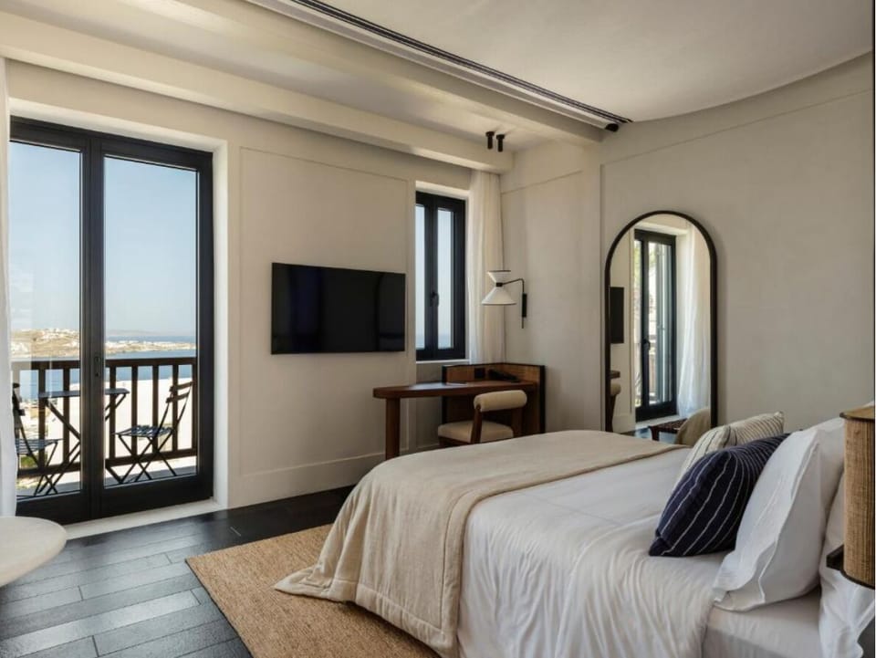 Lounge in style with TV comforts and breezy balcony access.