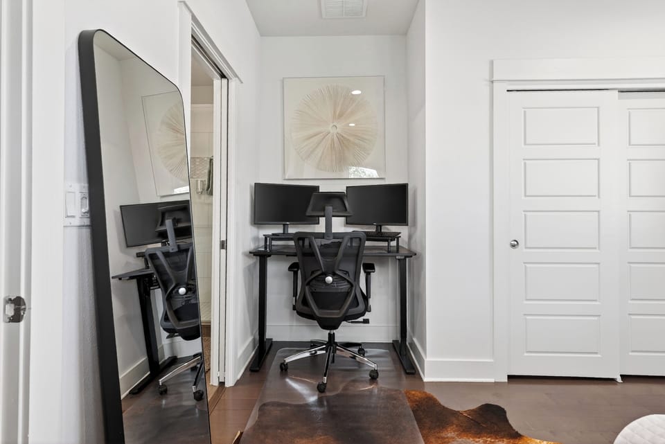 Bedroom 2 features a queen bed and a desk.