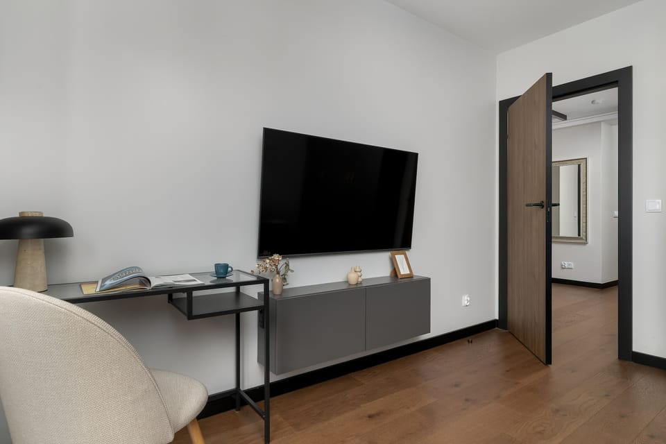 Compact room with a sofa bed and minimalist decor. The space can easily serve as a lounge or sleeping area.