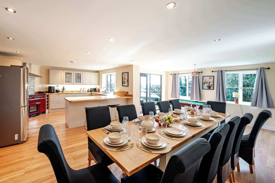 Enjoy a bright, welcoming space where dining, cooking, and leisure flow seamlessly, framed by large doors to the outdoors.