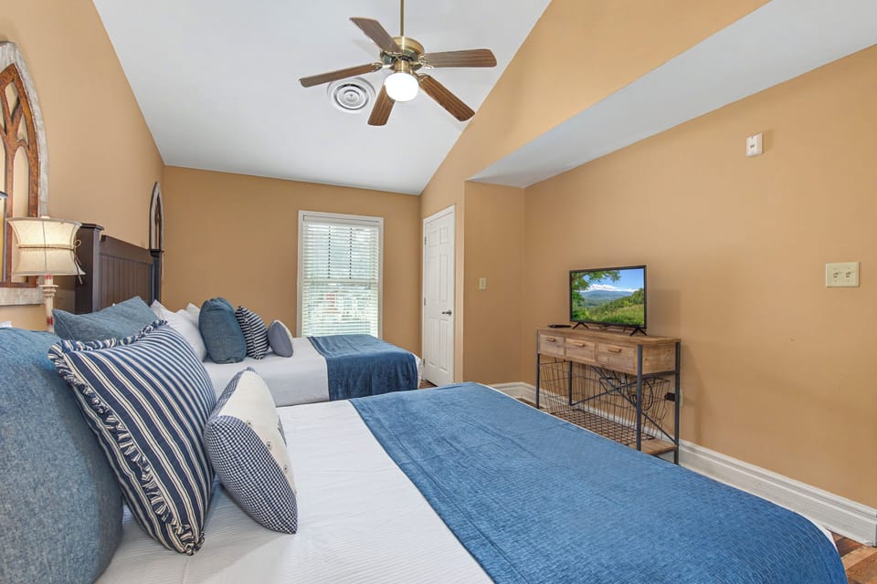 Unwind in your comfortable twin bedroom with soft linens, warm lighting, and entertainment for a restful night.