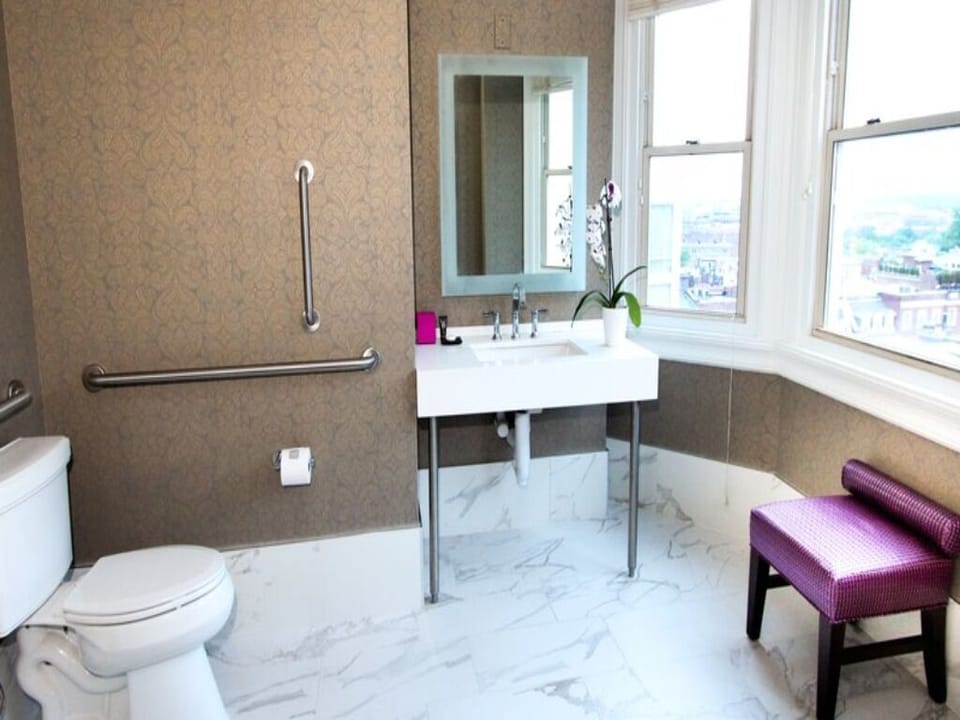 Refresh easily in a bright, accessible bath with city views.