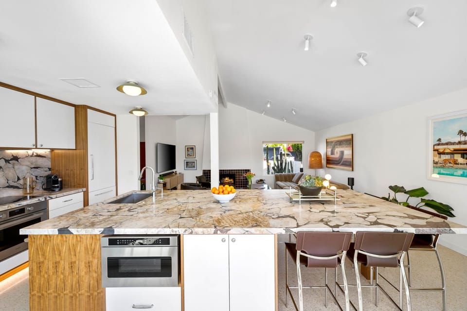 Your open-plan kitchen flows seamlessly into the living area, featuring stunning marble countertops perfect for morning coffee or evening conversations.
