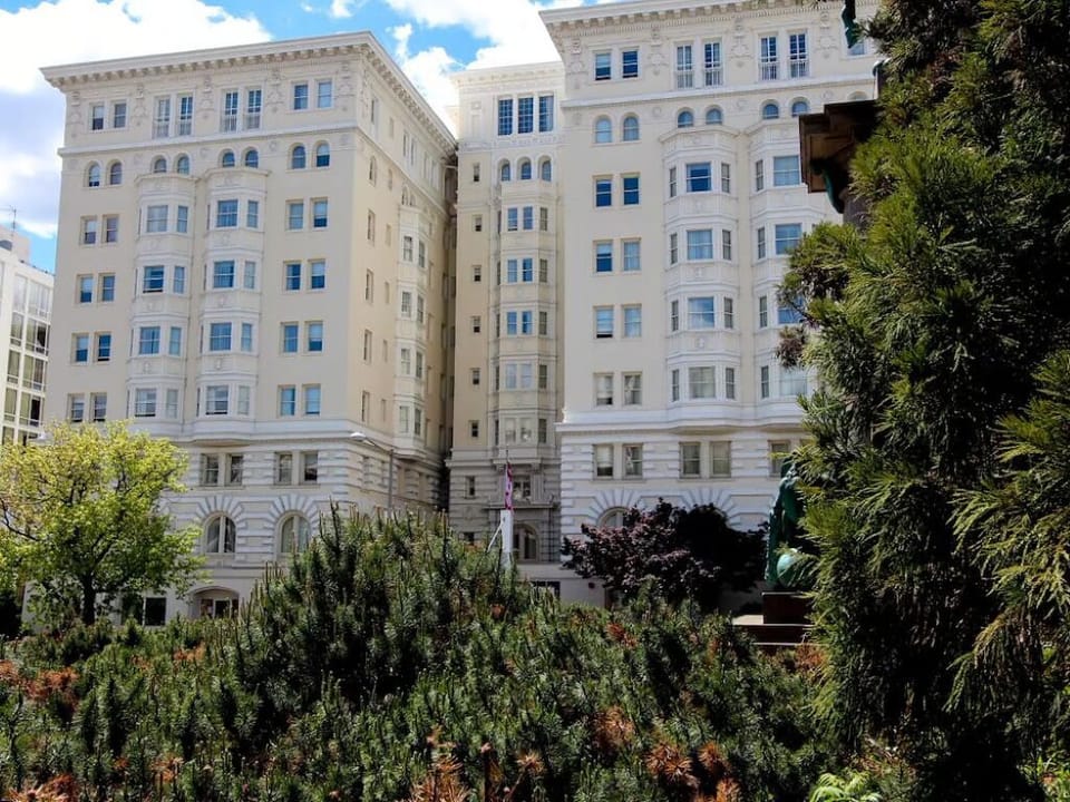 Enjoy serene garden views framing the hotel’s stately exterior.