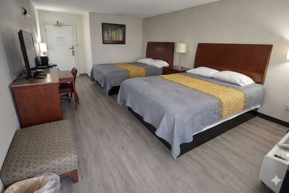 Settle in with roomy layout, desk, and warm bedside lamps.