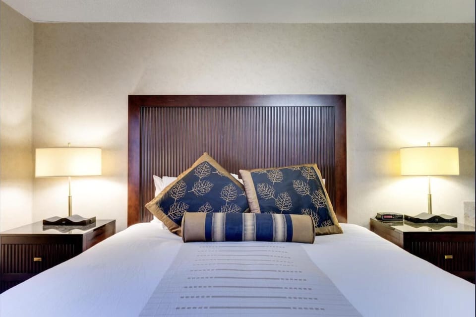 Drift off fast with plush pillows and cozy bedside lighting.