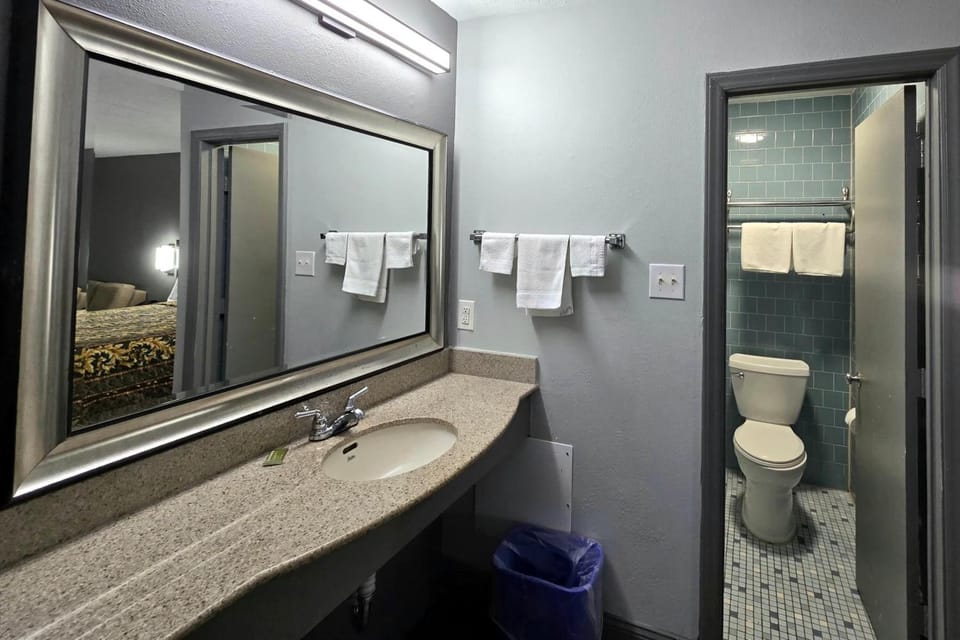 Get ready comfortably with a wide vanity and bright mirror.