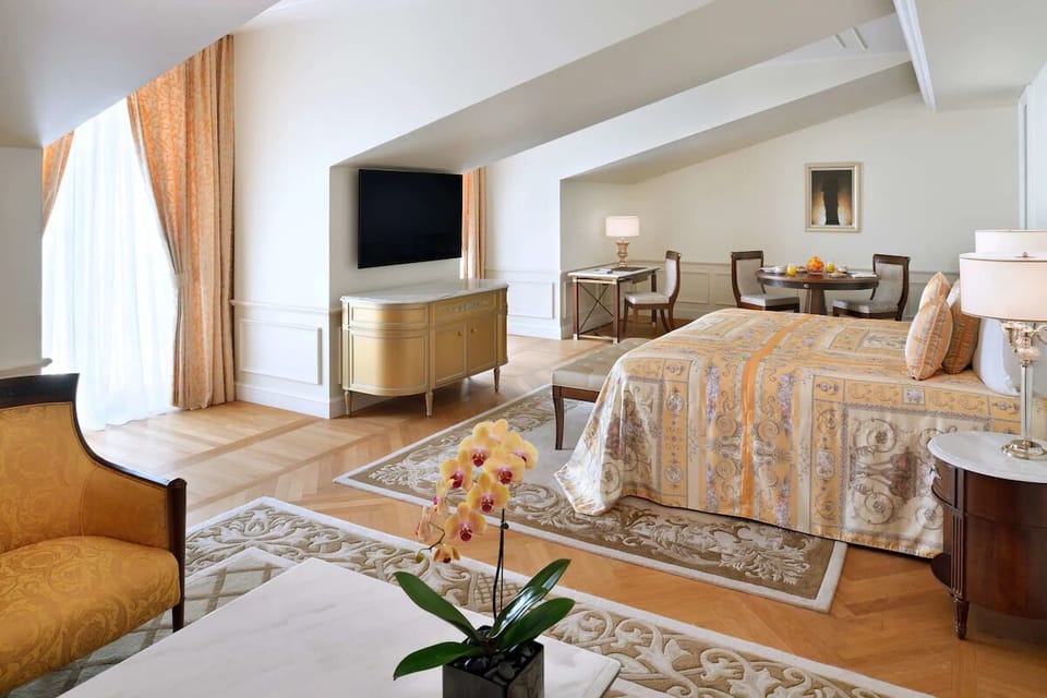 Lounge comfortably with a large TV and refined sitting area.