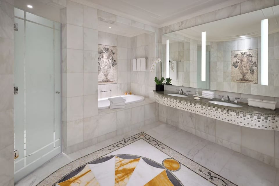 Indulge in a marble bath sanctuary with generous counter space.