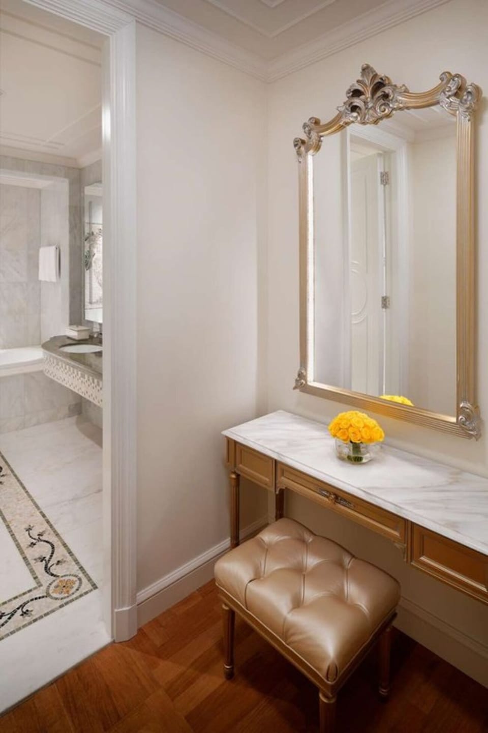 Get ready in style at a marble vanity and mirror.
