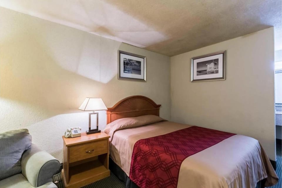 Recharge in a cozy corner room with bedside lighting.