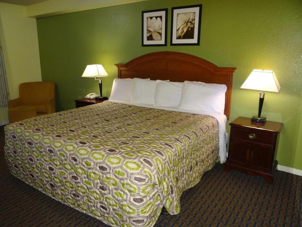 Sink into a plush king bed under warm lamplight.