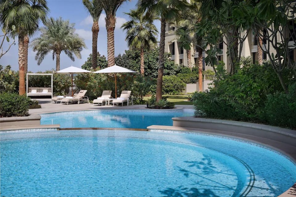 Unwind poolside beneath palms, soaking up serene sunshine.