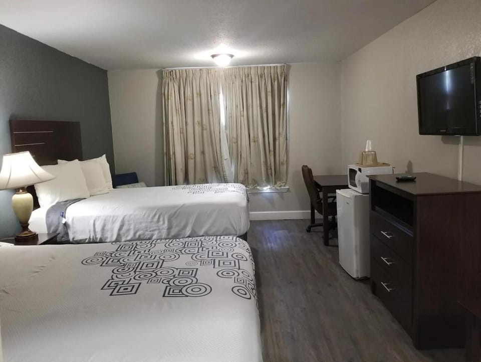 Relax in a bright room with two beds and workspace.