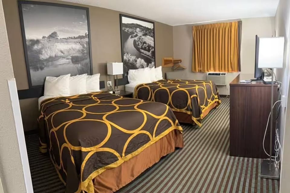 Drift into restful sleep between crisp pillows and warm lighting.