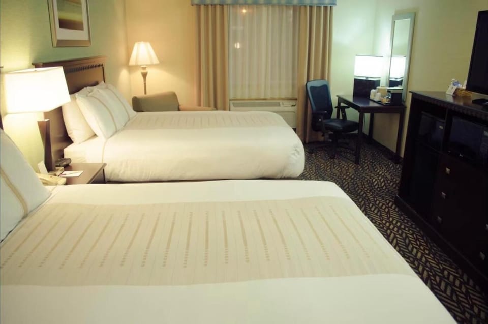 Ease into the evening with bedside glow and a handy workspace.