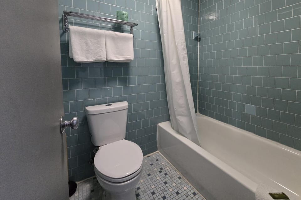 Start your day fresh with bright tile and plush towels.