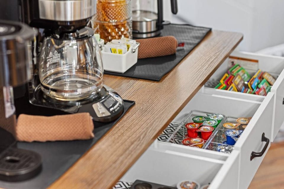 Start your day at the coffee station featuring--coffee maker, Keurig k-cup machine, pods, sugar & honey, cream, and a variety of teas.
