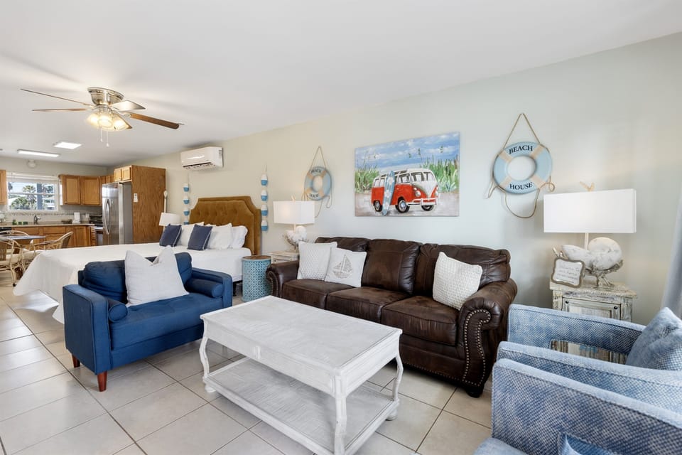 Relax in your bright, beach-themed living space where coastal charm meets comfort with plush seating and nautical touches.
