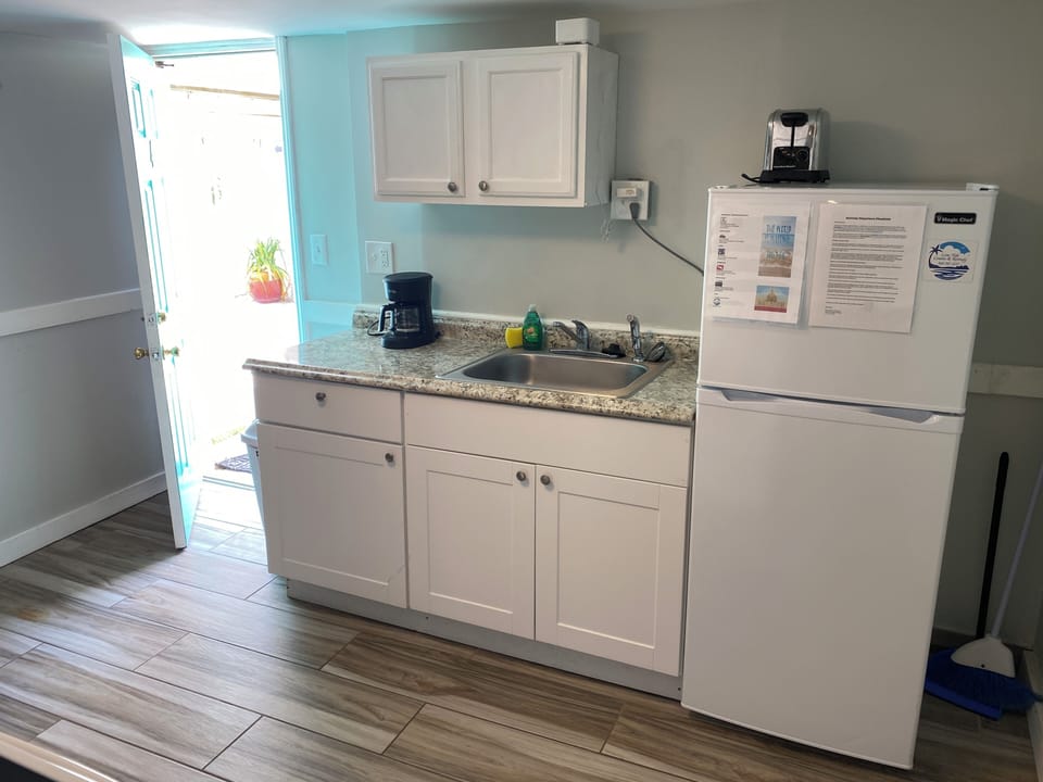 Your bright kitchenette has everything you need: granite counters, full-sized fridge, coffee maker, and sink with natural light streaming in.