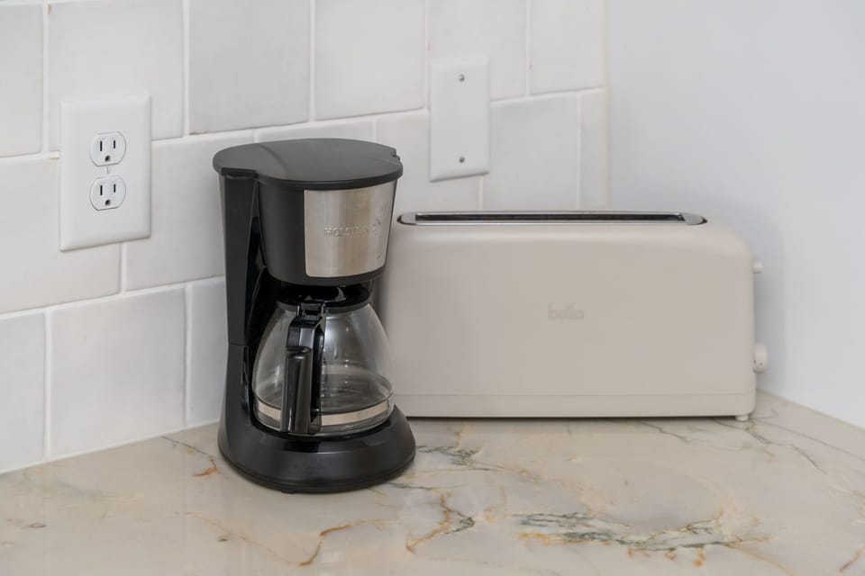 Start your mornings right with fresh coffee and golden toast from your well-equipped kitchen counter.