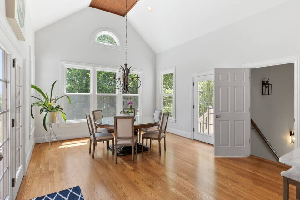 Dining table with seating for 6 off of the kitchen, and a door leading to the outside balcony on the main floor.