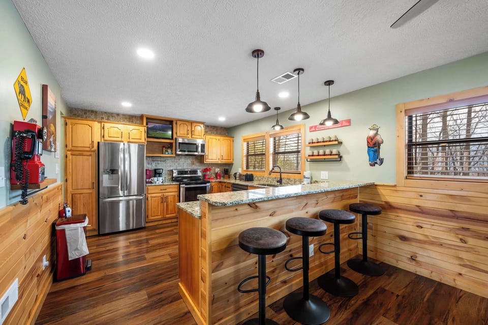Barstool seating around the kitchen counters. 
