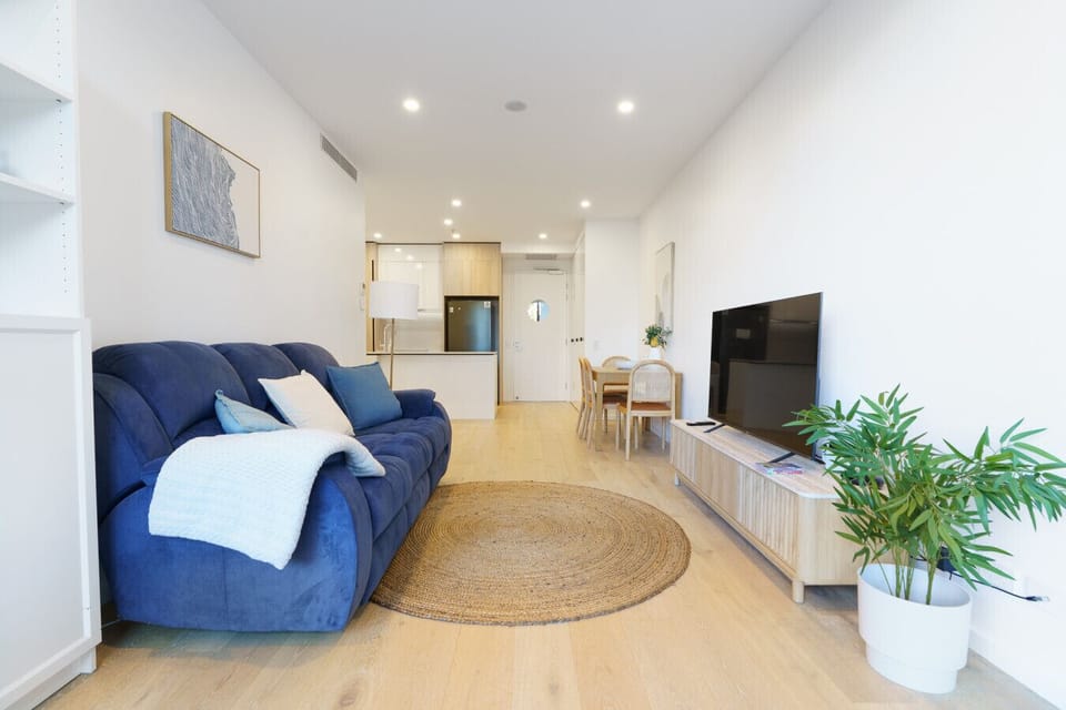 Comfortable living room with plush seating and a smart TV, ideal for quiet nights in and easy relaxation.