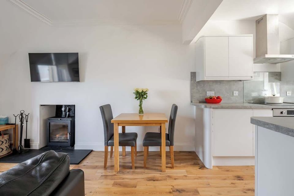 The open plan living area boasts a comfortable corner sofa. A table which folds out to comfortably seat 4, leading onto the well equipped Kitchen.