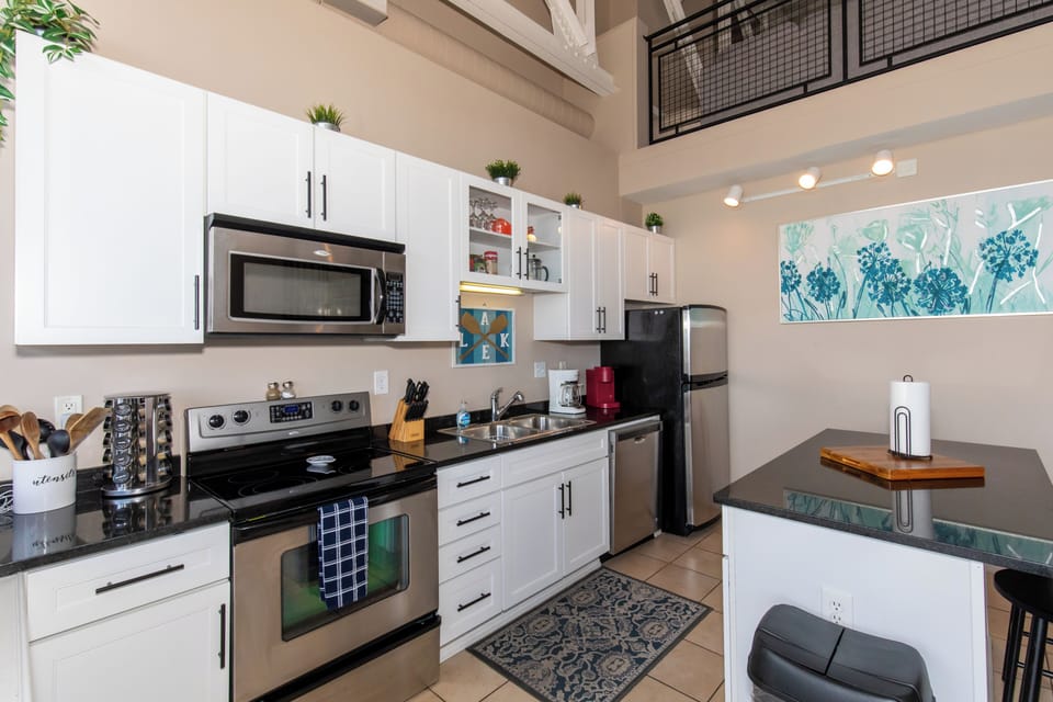 Your fully equipped kitchen features modern appliances, granite counters, and a breakfast island perfect for cooking and dining together.