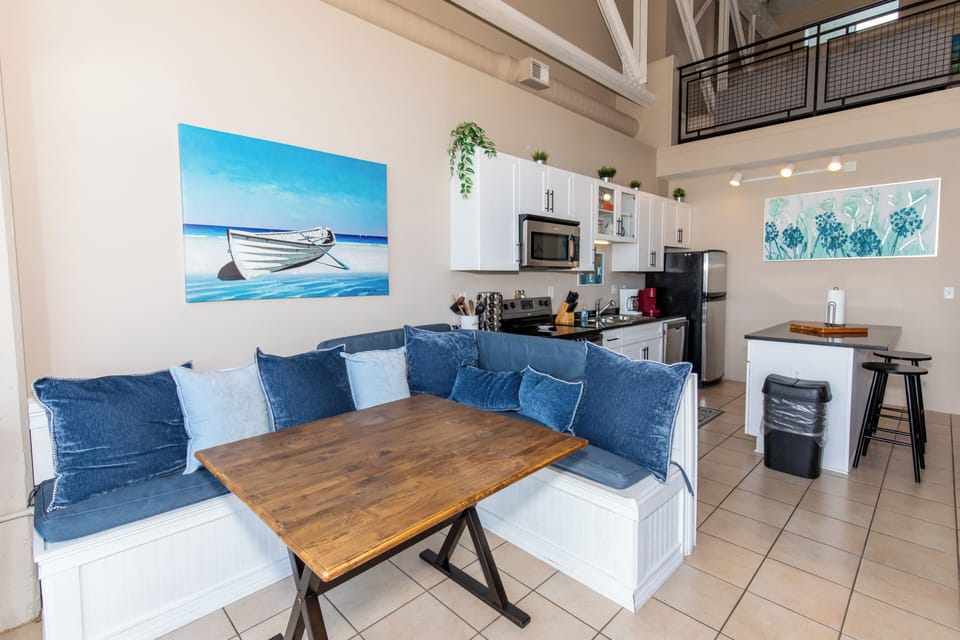 Your stylish loft features an open-plan kitchen perfect for preparing meals while staying connected with loved ones in the cozy dining nook.