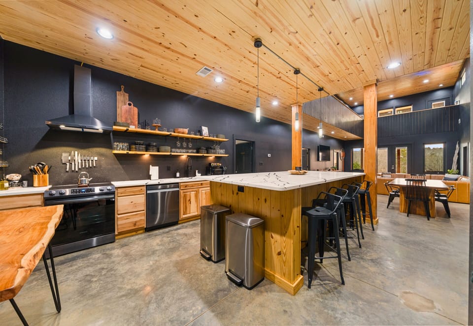 The spacious kitchen is designed for gathering, with plenty of counter space, warm wood cabinetry, and room for everyone to jump in and help with meals.