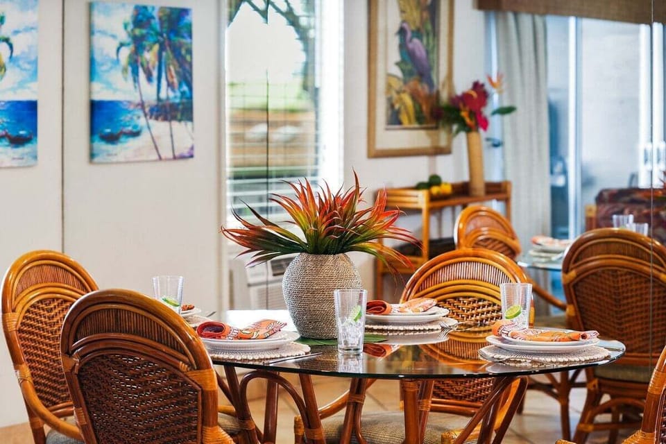 Bright indoor dining area with elegant wicker seating, reflecting the warm and inviting spirit of Maui.
