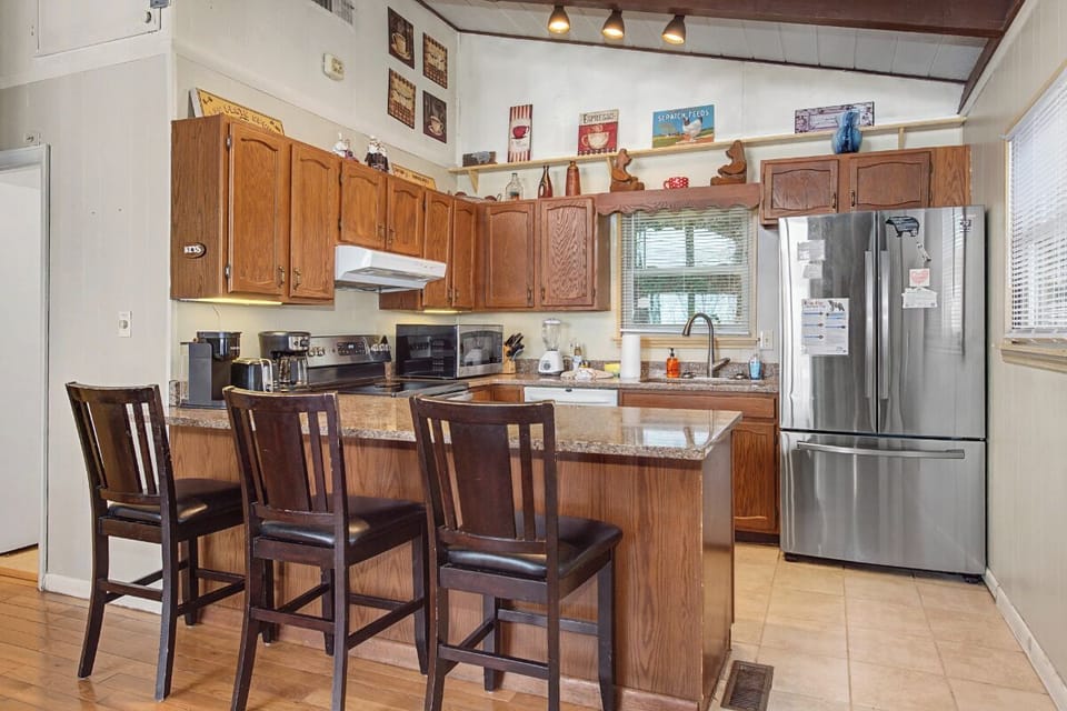 Your fully equipped kitchen features granite counters, stainless appliances, and a breakfast bar where you can savor morning coffee.