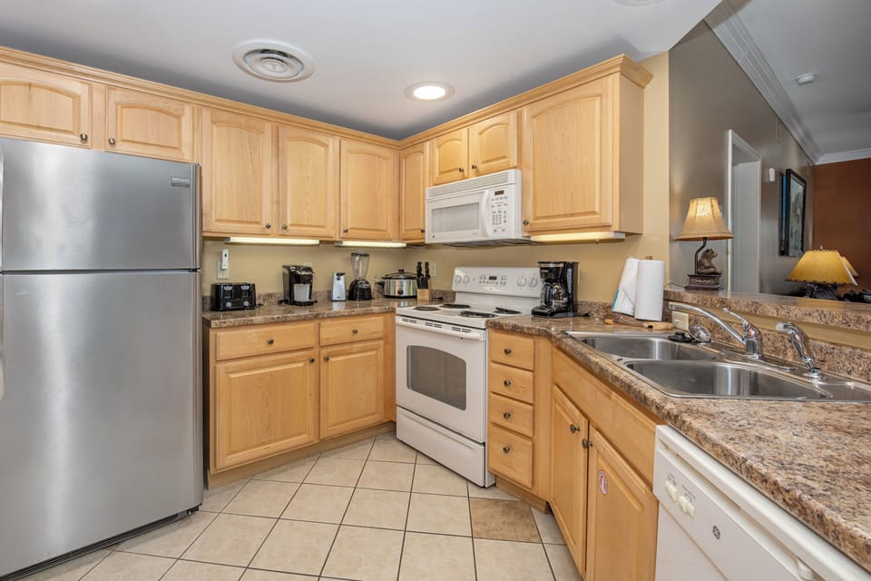 Prepare your favorite meals in this fully equipped kitchen featuring granite countertops, stainless steel appliances, and everything you need for cooking.