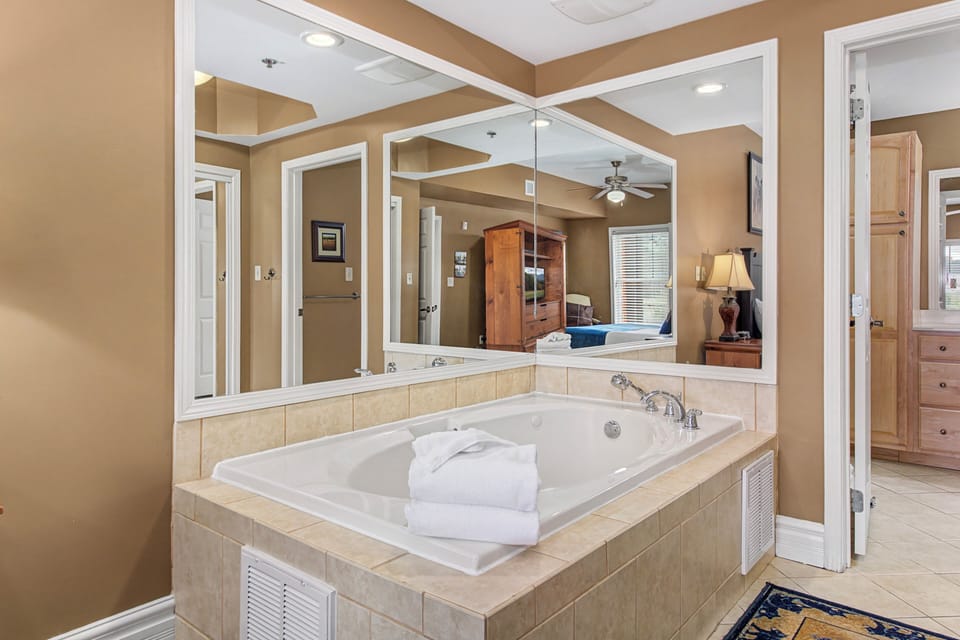 Unwind in your private soaking tub with soft towels and elegant tile surroundings for the ultimate relaxation.