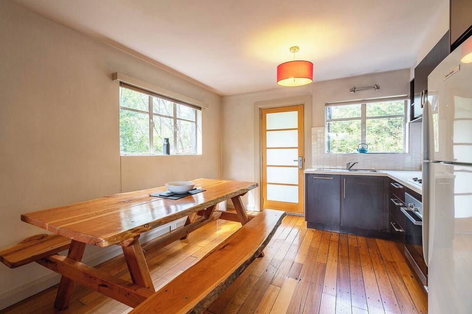 This long, timber dining space is perfect for shared meals or a relaxed morning coffee.