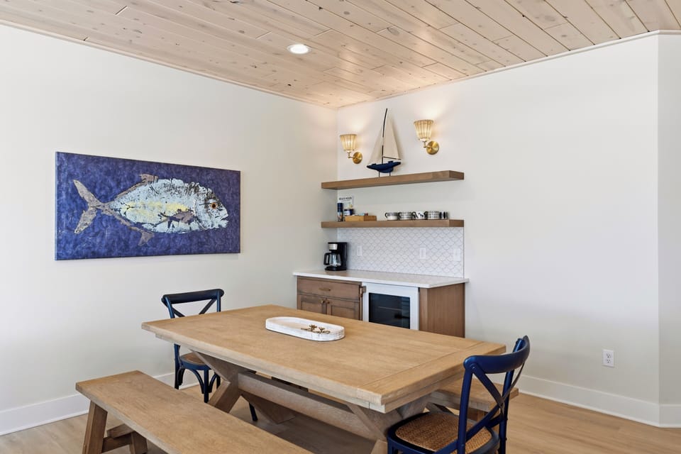 Rustic farmhouse dining table with nautical art and coffee bar